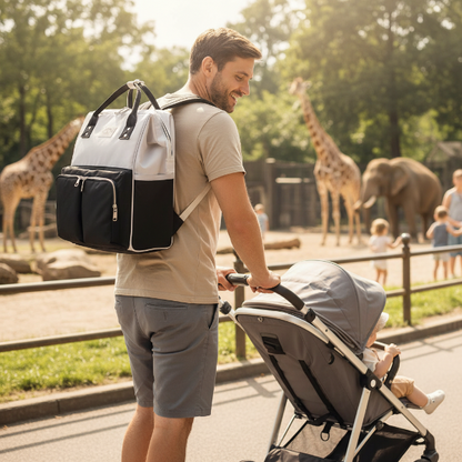 Papa porte le sac à dos à langer lors d'une sortie au zoo avec bébé dans sa poussette