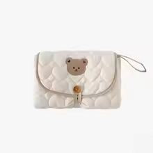 Tapis a langer nomade tete ourson plier